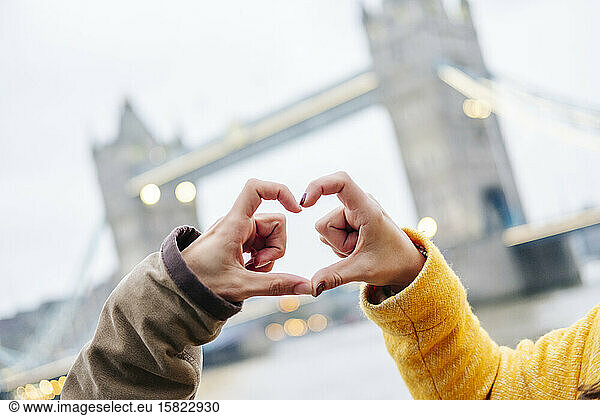 London  United Kingdom  Couple making heart-shaped finger frame