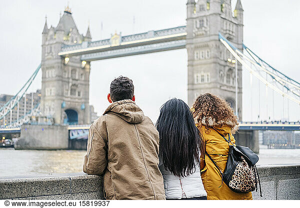 London  United Kingdom  Group of friends looking at Tower Bridge