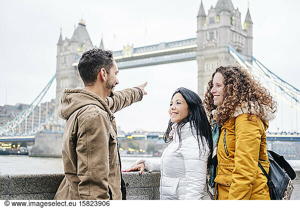 London  United Kingdom  Group of friends looking at Tower Bridge