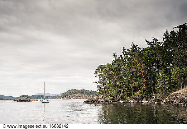 Lone sailboat moored on cloudy day on Lopez Island WA