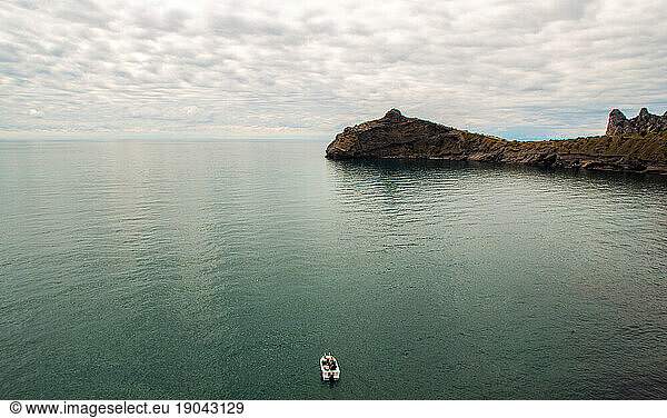 Lonely boat in the Sea Cove with sunset