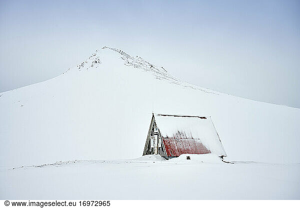 Lonely house in snowy northern terrain