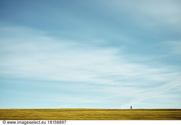 Lonely person on countryside field
