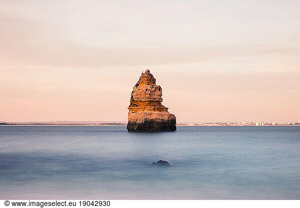 Lonely rock in the ocean at Lagos  Algarve  Portugal. Long exposure