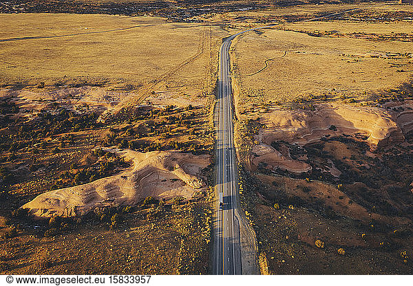 Lonely Utah's road in the evening with a truck from above