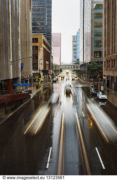 Long exposure of vehicles moving on city street during rainy season
