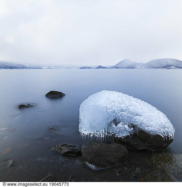 Long exposure shot of rock covered in ice at lake Toya  Hokkaido  Japan
