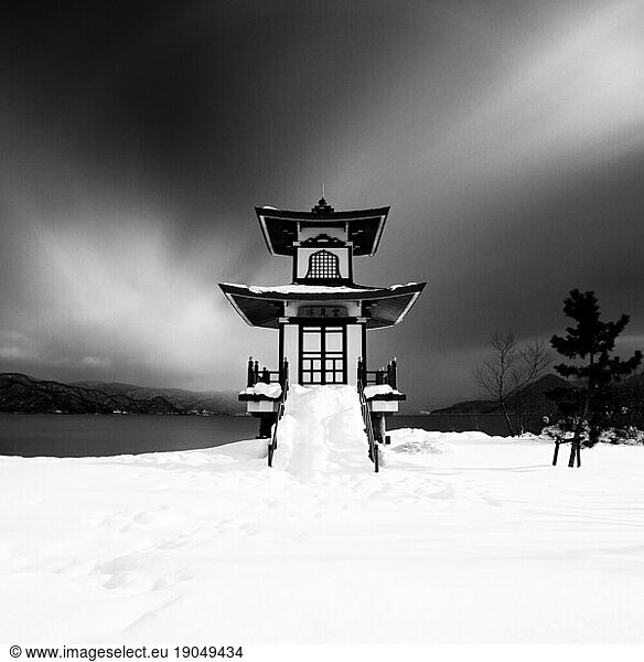 Long exposure shot of Ukimido shrine covered in snow at lake Toya  Hokkaido  Japan