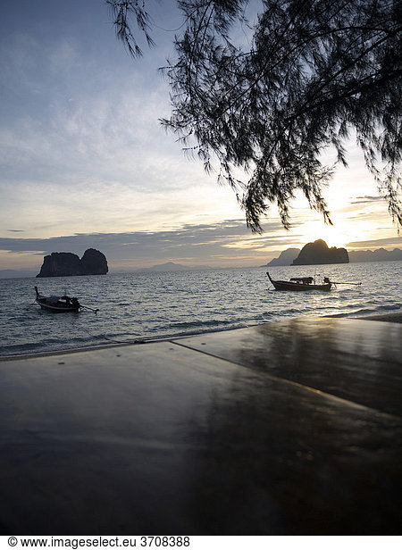 Long tail boats at dawn with a group of rocks off the beach of Ko Hai island  Ko Ngai out  Andaman Sea  Satun Province  southern Thailand  Thailand  Asia