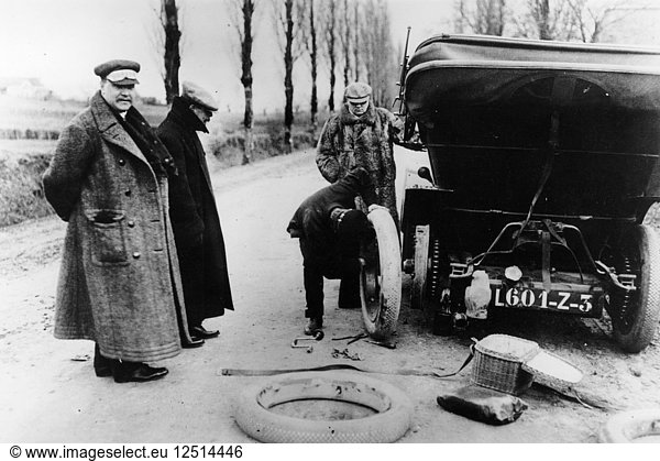 Lord Northcliffes chauffeur changing a tyre  (c1908?). Artist: Unknown