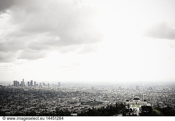 Los Angeles Skyline and Griffith Observatory Beneath Cloudy Sky
