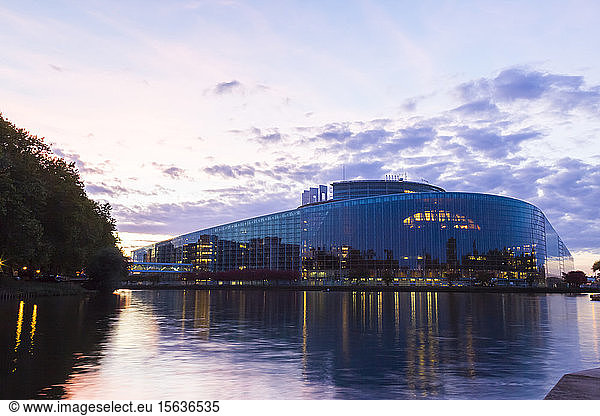 Louise Weiss building by river against sky at sunset  Strasbourg  France