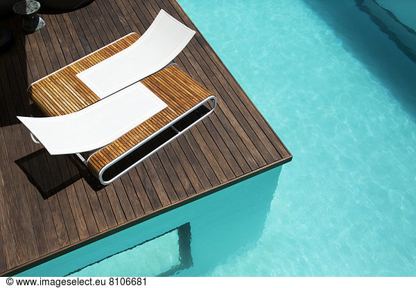 Lounge chairs at luxury poolside
