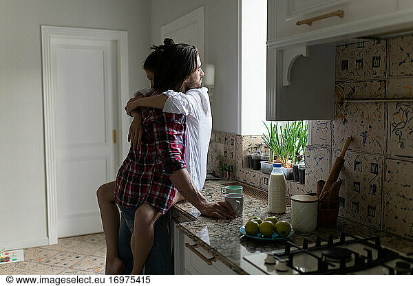 Lovely Beautiful Couple Standing And Hugging On A Kitchen