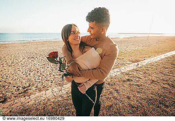 Lovely Shot Of A Young Couple In Love Hugging On The Beach