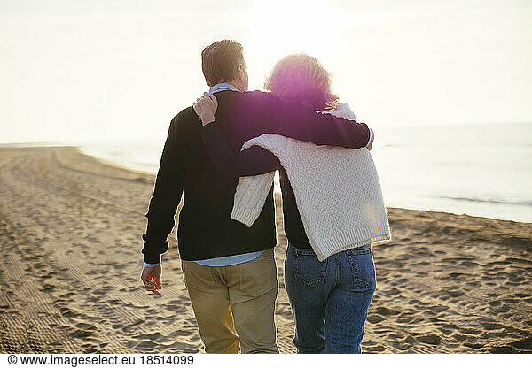 Loving mature couple walking together at beach