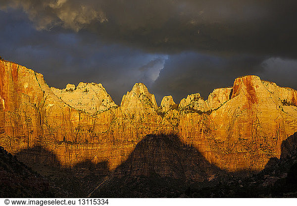Low angle idyllic view of mountain ranges against stormy clouds at Zion National Park