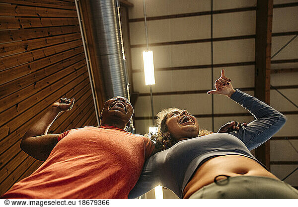 Low angle of female athletes gesturing and enjoying together at sports court