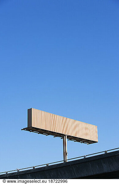 Low angle view of a empty road sign above the freeway.
