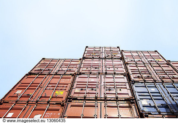 Low angle view of cargo containers against clear sky