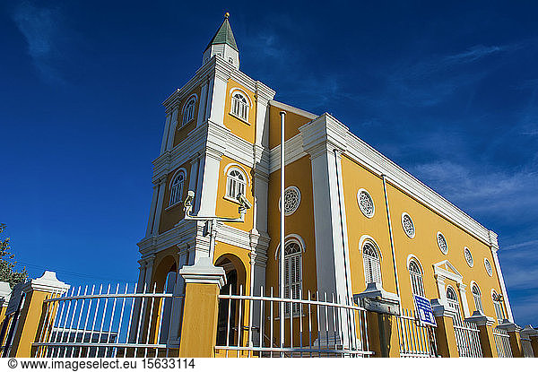 Low angle view of church against blue sky in Willemstad City  CuraÃ§ao