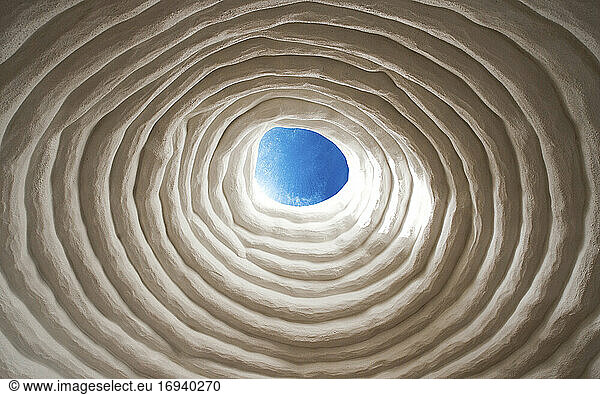 Low angle view of coiled white ceiling.
