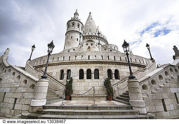 Low angle view of Fisherman's Bastion against cloudy sky