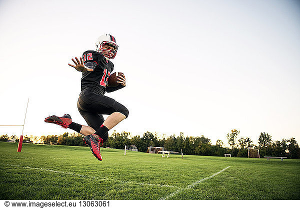 Low angle view of high school football player posing