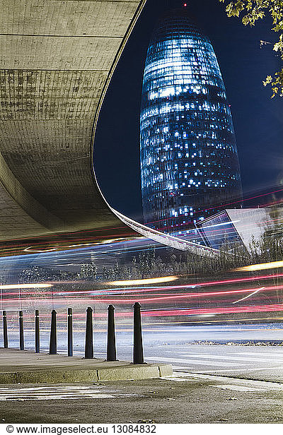 Low angle view of light trails against illuminated Torre Agbar