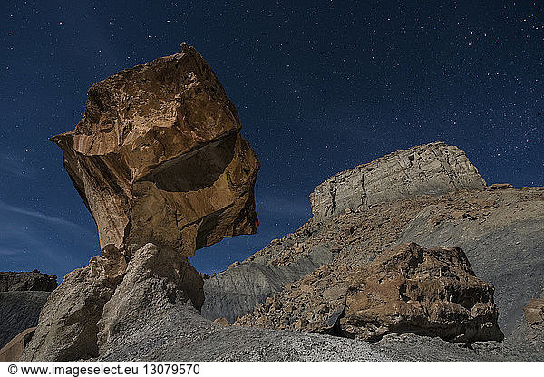 Low angle view of rock formations against star field at Grand Staircase-Escalante National Monument