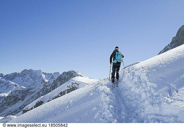 Low angle view of skier climbing the ski slope  Bavaria  Germany  Europe