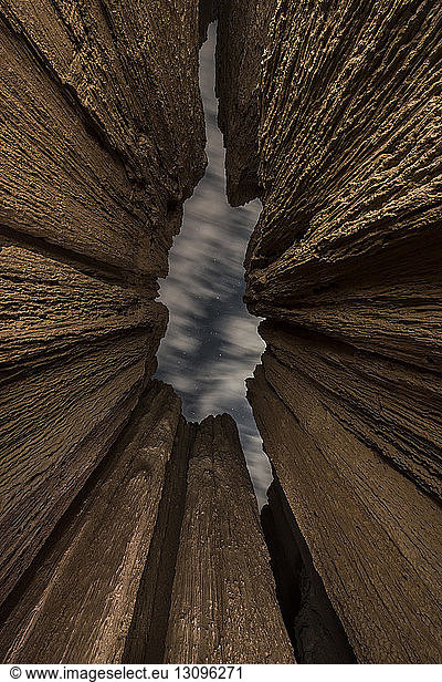 Low angle view of slot canyons against cloudy sky at Cathedral Gorge State Park