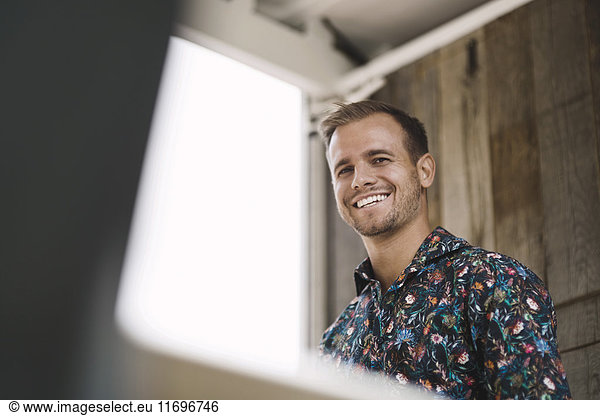 Low angle view of young businessman smiling in portable office truck