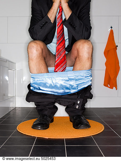 Low section of man defecating