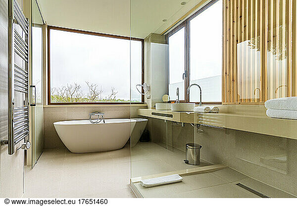 Luxury bathroom with glass wall at hotel