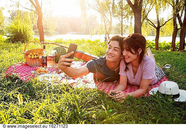 Lying on the grass pictures of happy couples