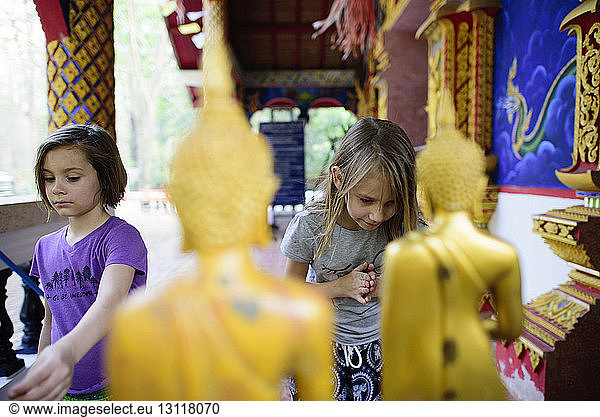 Mädchen beten im buddhistischen Tempel