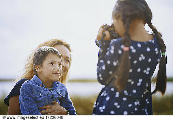 Mädchen fotografiert Mutter und Bruder