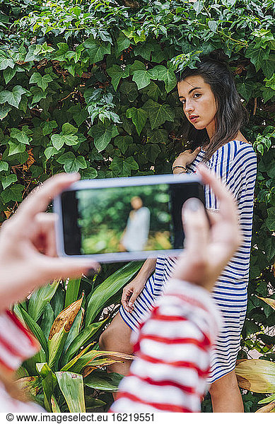Mädchen fotografiert Schwester durch Smartphone
