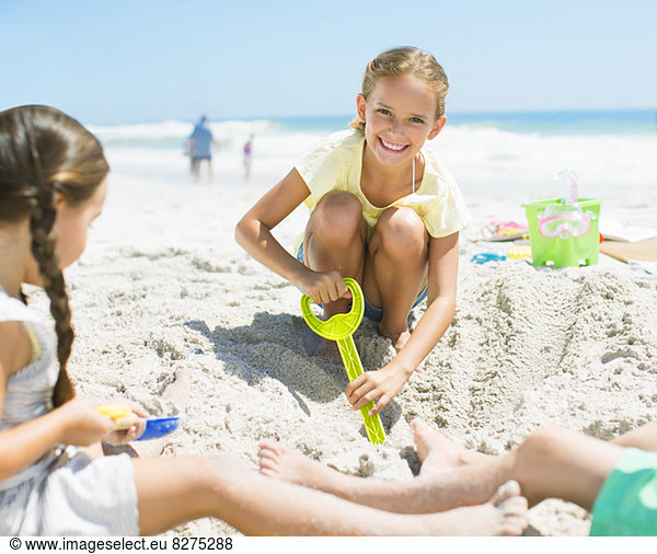Mädchen graben im Sand am Strand