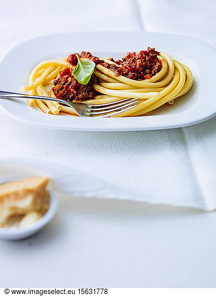 Macaroni with Bolognese sauce in plate on table
