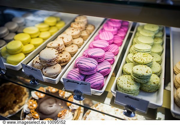 Macarons in trays in display cabinet  close-up