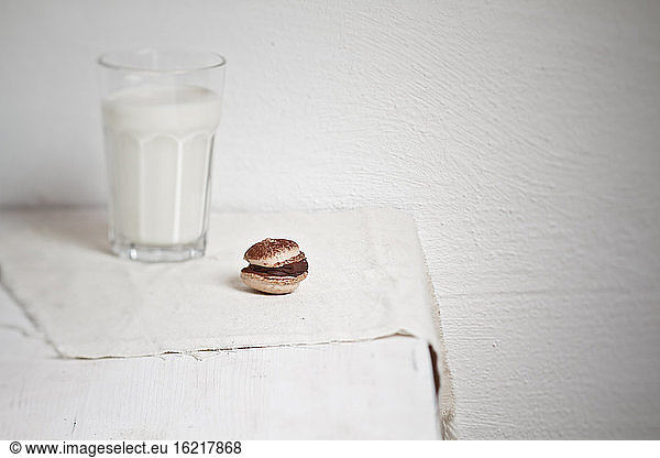 Macarons with chocolate ganache and glass of milk