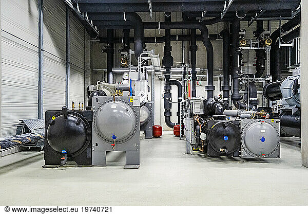 Machines and pipework in a factory for energy distribution
