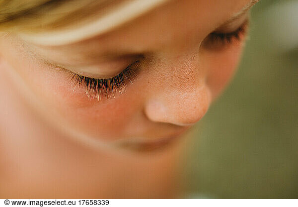Macro lose up of young boy's blonde eyelashes and freckles