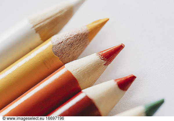 Macro view of red orange yellow coloring pencils