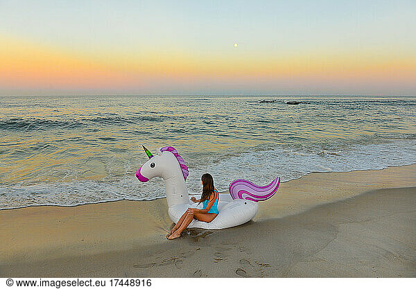 Magical Girl Sits On Unicorn Raft On Beach In Spring Lake  New Jersey
