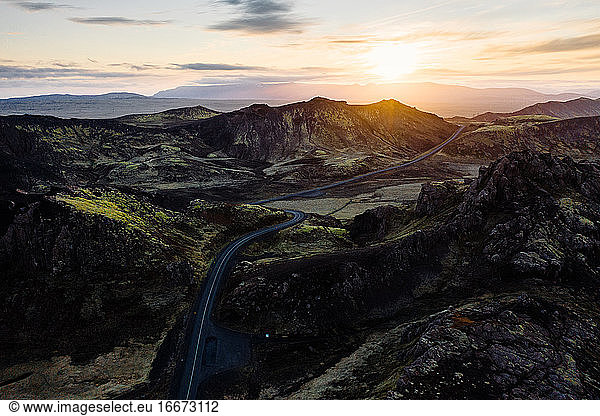 Magnificent sunset over road in mountainous terrain