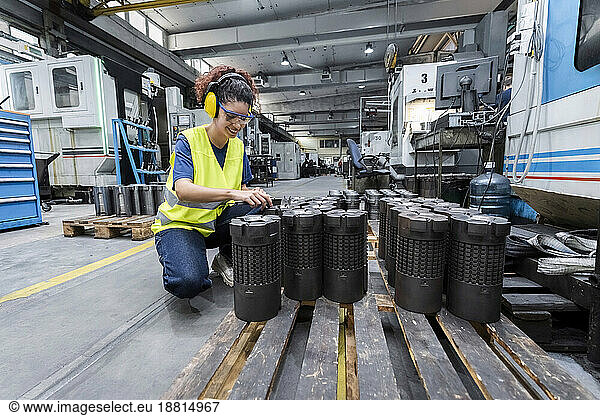 Maintenance engineer in reflective clothing working in factory