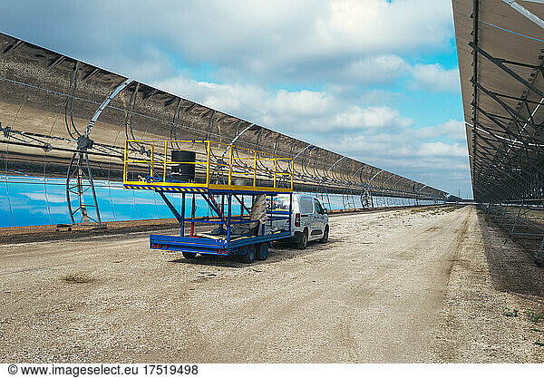 Maintenance team cleaning the panels of a solar thermal power plant.